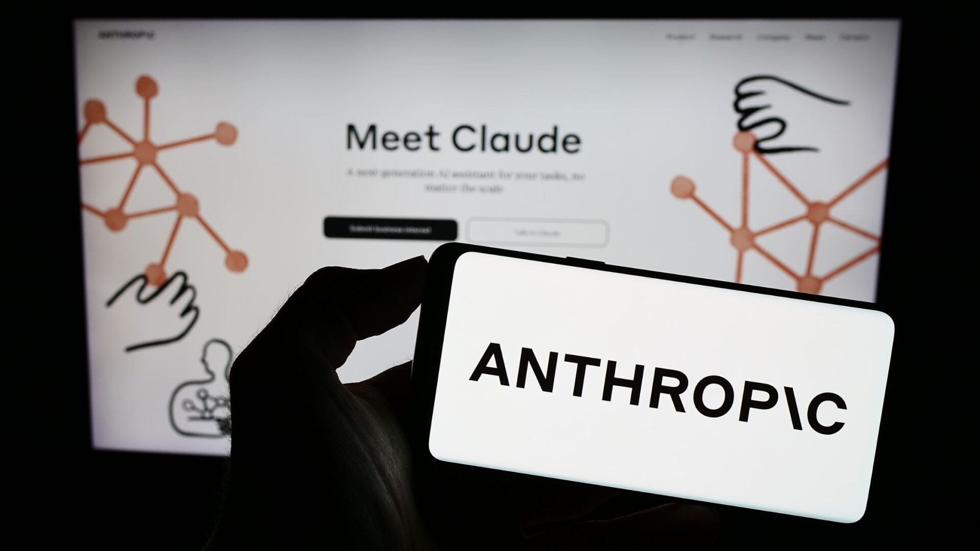 Stuttgart, Germany - 07-21-2023: Person holding mobile phone with logo of US artificial intelligence company Anthropic PBC on screen in front of web page. Focus on phone display. Unmodified photo. (T. Schneider/Shutterstock.com)
