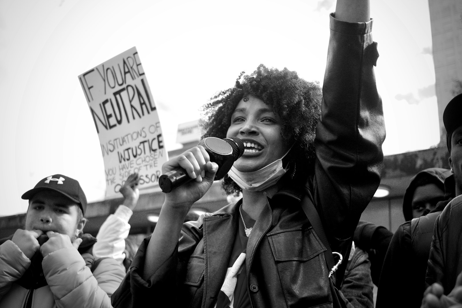 Photo by Sushil Nash grayscale photo of man in black jacket holding black smartphone