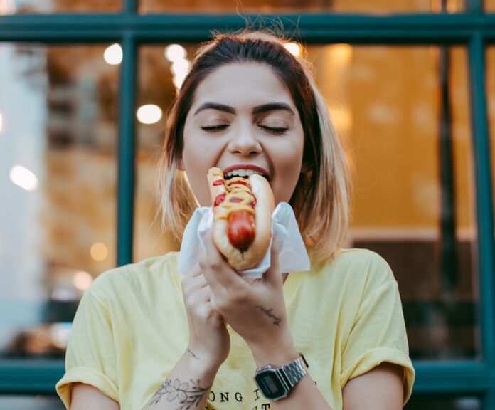 woman in white crew neck t-shirt eating apple