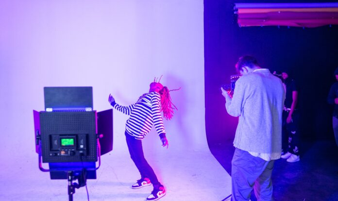 girl in black and white striped long sleeve shirt and pink pants standing beside black flat