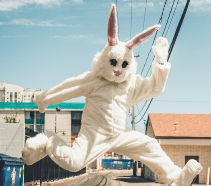 man in bunny costume in mid air in time lapse photography