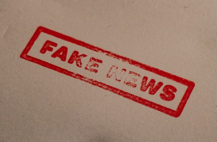 a stamp that reads fake news on a piece of paper