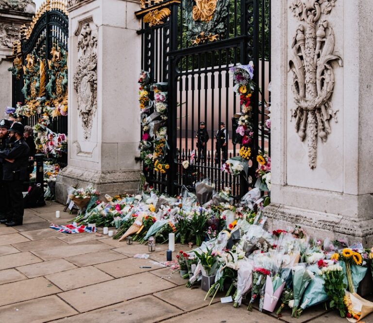 a gate with flowers and a clock on it