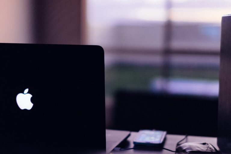 a laptop computer sitting on top of a wooden desk