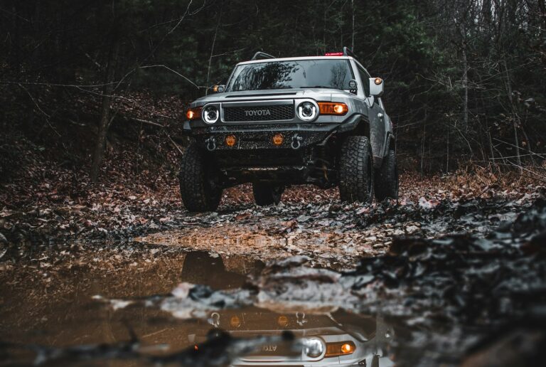 a jeep driving through a muddy area