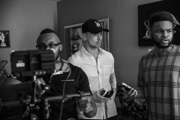 man in white dress shirt holding a clear glass mug