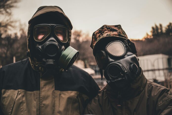 grayscale photo of person wearing gas mask